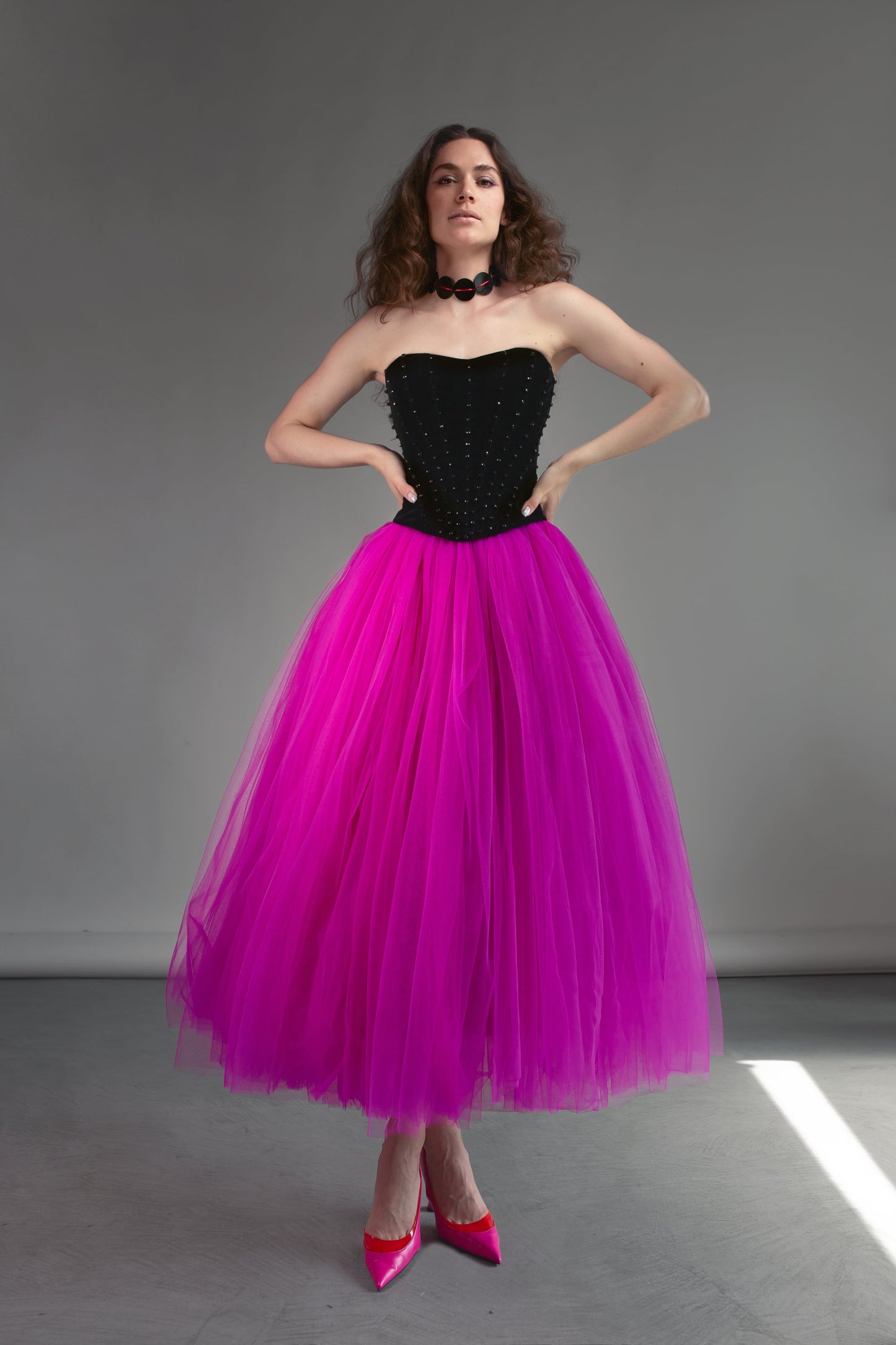 Black corset with stones and voluminous red violet tulle skirt